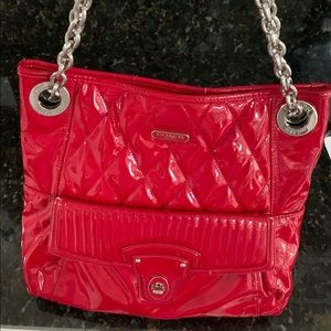 Coach satchel with combo leather and chain handle.